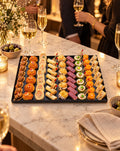 Savory Eiffel canapé platter at an aperitif party with champagne