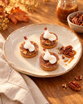 Mini pecan pie petit fours with whipped cream, pecans and caramel