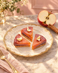 Mini tarte tatin petit fours on a gold-rimmed plate with a fresh apple